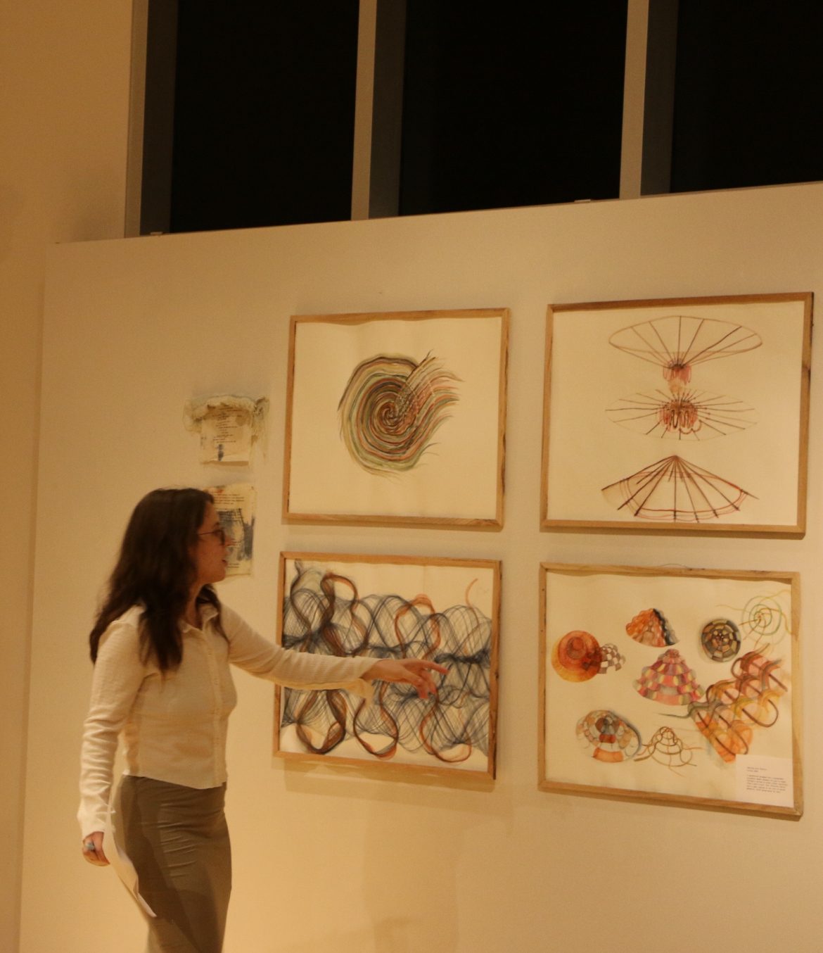 Framed watercolor works on paper in a gallery
